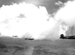 B-25 Mitchell bombers and P-38s in flight in the CBI, in the area of southern China, Indochina, or Burma.