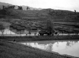 Tent city of flooded living quarters at Liangshan. Stream next to the site has overflowed in this image. During WWII.