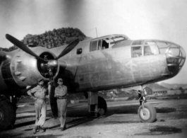 "Proud of Our Work On This Aircraft--Bukey and Miller pose for a photo in front of Casey Vincents B-25 The Silver Slipper at Kwelin [Guilin], China." Caption courtesy of Elmer Bukey.