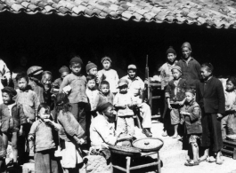 Restaurant 10 miles east of Yangkai, Spring 1945.  Clayton E. "Fred" Nash, holding carbine, does not quite blend in.