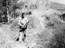 "Fred Nash, several miles south of Yangkai, in a group of burial mounds, just before having lunch. Spring, 1945."  From collection of Frank Bates.