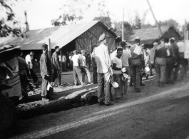 GIs of 7th Veterinary Company pose with mess gear in front of tents in the CBI during WWII.