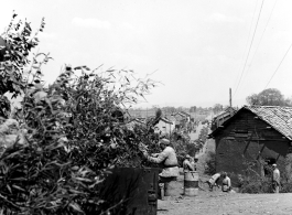 Row of vehicles, and Chinese soldiers with equipment ready and covered in camouflage during exercises in southern China, in Yunnan province.  Despite the appearance of being on their way to battle, these men are more likely in fact prepared for a demonstration or honor parade. 