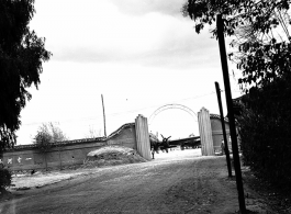 Guarded gates of the Nationalist Kunming Air Force Officer Training School during WWII, with C-46 transports.