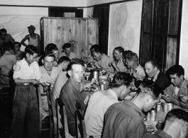 GIs eating nice meal in club house or nice mess hall in Yunnan, China, during WWII.