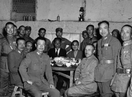 Table of local ranking Nationalist leadership during the banquet at the rally. In foreground, left, is Chinese Lt. General Du Yuming, commander of Nationalist 5th Corps (第五集团军总司令兼昆明防守司令杜聿明). Sitting turned, on right, is Gen. Wei Lihuang (卫立煌). Standing on far right is Zheng Tingji (郑庭笈), commander of the 48th Army Division (陆军第四十八师 ).  The general seated on the far left is Qiu Qingquan (邱清泉).  The two civilians seated in the back are KMT civilian officials. The one on the right is likely An Zefa (安则法), a hi