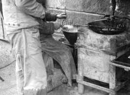 "This Chinese vendor located his 'place of business' along the road from Kunming to Chengdu. He was selling small nuts that were deep fried. An American convoy stopped in this area and an American soldier took advantage of the time to make a purchase."