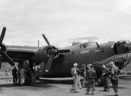 A shark-mouth B-24, the mouth having a unique curl at the back, in a revetment in SW China, likely Sichuan, during WWII. This is a later model B-24 as indicated by the nose turret with two .50 cal machine  guns.