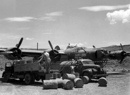 The B-24 "Maxwell House II" being refueled in a revetment in SW China, likely Sichuan, during WWII.