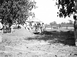 Solemn burial ceremony for American GIS who had died at a temporary war-time graveyard. In the CBI, during WWII.