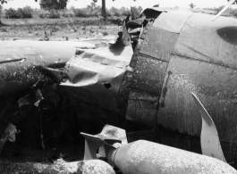 Wrecked B-25 Mitchell bomber on the ground in the CBI. The wreck was apparently at an air base, and probably on take-off, as the craft is sprayed with fire-retardant foam, and bombs are scattered about the wreck site. During WWII.