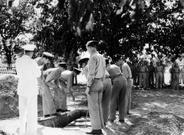 Solemn burial ceremony for American GIS who had died at a temporary war-time graveyard. In the CBI, during WWII.