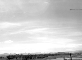 A view across part of American air base at Liuzhou in 1945, after being reoccupied by American and Chinese forces following Japanese withdrawal in 1945. Note apparent B-25 in tidy revetment, driving jeep, and ruins of base buildings, destroyed during Allied retreat, Japanese occupation, and again during Japanese withdrawal.