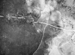 Bombs explode on a remote automobile road in either SW China (esp. Guangxi), or Burma, or French Indochina during WWII.