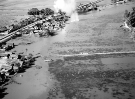 Bombing of small rail bridge, among a flood plain, in French Indochina during WWII.