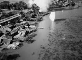 Bombing of small rail bridge, among a flood plain, in French Indochina during WWII.