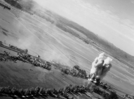 Bombing of small rail bridge, among a flood plain, in French Indochina during WWII.