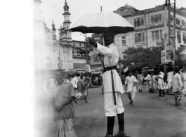 In the India during WWII: A diseased person next to railroad tracks (top), a police officer directing traffic in Calcutta in 1944 (middle), and farm people picking rice in Assam in 1944 (bottom).