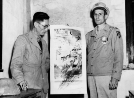 A Chinese representative of the Air Transport Office of the SYEHA WTB presents a picture to commemorate the 38th anniversary of the USAAF to an officer of the ATC at Chanyi, China. During WWII.