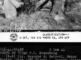 Cpl. Raymond B. Gutoski, Pfc. Virgil A. Horner, S/Sgt. George A. Boden, of 2nd Platoon, 704th AB AAA Battalion, on duty guarding the Tengchong airstrip, are shown cleaning their .50 caliber water-cooled machine gun.  Yunnan Province on December 5, 1944.  Photo by T/Sgt. S. L. Greenberg.  Passed by censor Samuel Goldberg.