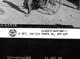 Rickshaw puller poses with his customer, Cpl. William C. Burwinkel.  Yunnan Province on December 13, 1944.  Photo by T/5 John B. Hendrick.  Passed by William E. Whitten.