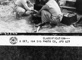 T/4 Kendrick M. Hemingway, cook for the BRE in the Kao district, si seen taking a pie out of a stove in the field.  December 2, 1944.  Photo by T/5 Milton Koff. 164th Signal Photographic Company, APO 627.