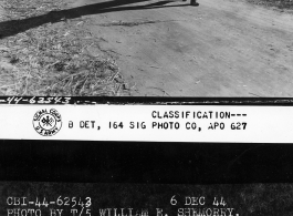 Chinese soldiers salvaging large pieces of sheet metal to sue in construction of shelters. Zhefang is half built and half littered with pieces like this.  December 6, 1944.  Photo by T/5 William E. Shemorry. 164th Signal Photographic Company, APO 627.  Passed by William E. Whitten.