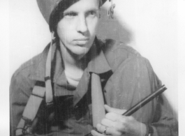 Sgt. Vern P. Martin posing with helmet and carbine in China during WWII.