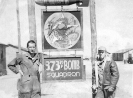 Mechanics pose with 373rd Bombardment Squadron HQ sign, presumably at Luliang air base, Yunnan, China. During WWII.