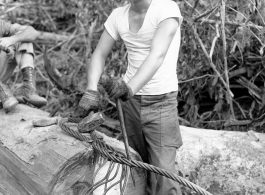 Engineer of the 797th Engineer Forestry Company in Burma, weaving a pulling eye in cable.  During WWII.