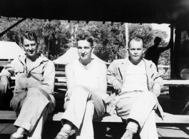 Engineers of the 797th Engineer Forestry Company pose a plank mess tables at a camp in Burma.  During WWII.