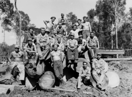 Engineers of the 797th Engineer Forestry Company pose on logs in Burma.  During WWII.