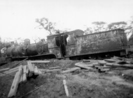 A shot up steam railroad engine, showing large number of bullet or shrapnel holes, derelict in Burma.  During WWII.  797th Engineer Forestry Company.