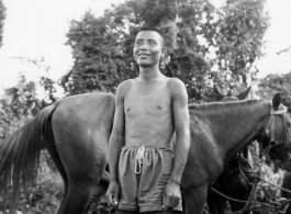 Local people in Burma near the 797th Engineer Forestry Company--A man poses with horse.  During WWII.