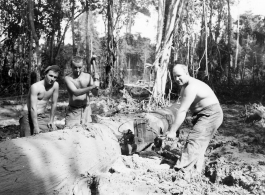 GIs cutting bucking downed trees in Burma for lumber mill.  During WWII.  797th Engineer Forestry Company.