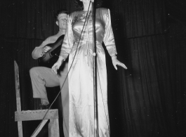 Performers well off the beaten track, providing a break for Burma Road engineers of the 797th Engineer Forestry Company--Jimmy Dodd and Ruth Carrol play guitar and sing.  During WWII.