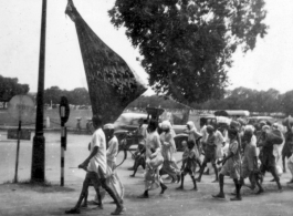 People with large banner marching in India, during WWII.