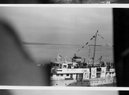 The welcome ferry "Miss America" with a band and civilian women in New York Harbor as the troopship MS Torrens arrives home, in late 1945.