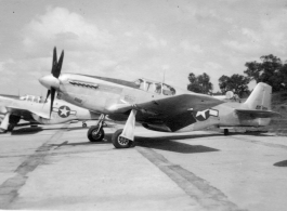 A P-51 fighter on pavement at an American air base in Burma during WWII.