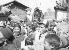 A village protective deity is paraded around the village as part of a festive celebration timed to the lunar calendar.  During WWII.