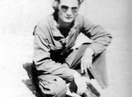 American flyer Tom Zera kneeling on ground.  22nd Bombardment Squadron, in the CBI.