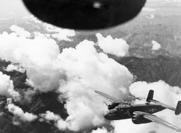 B-25s of the 22nd Bombardment Squadron in flight over rough mountains of SW China or Burma during WWII.