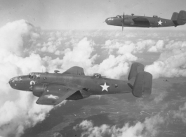 B-25s of the 22nd Bombardment Squadron in flight over wet plains in SW China or Burma during WWII.