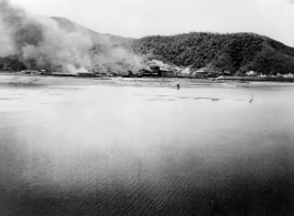 The coaling station at Campha Port, French Indochina, is left burning after bombing raid by B-25s.  22nd Bombardment Squadron.