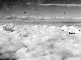 B-24s in flight near Kunming, China, during WWII, including the B-24 "Ubangi Bag II," #241168.