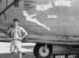 Flyer standing with B-24/F-7 "Nosie Rosie." 24th Combat Mapping Squadron, 8th Photo Reconnaissance Group, 10th Air Force