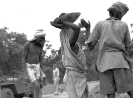 Laborers work at an American base in India, during WWII.