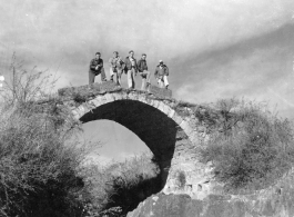 American flyers exploring thin stone bridge at Chanyi (Zhanyi), during WWII.