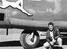 Flyer kneeling with F-7A "Rice Pattie Hattie." 24th Combat Mapping Squadron, 8th Photo Reconnaissance Group, 10th Air Force