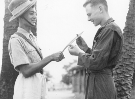 John Wolfshorndl inspects Ghurka knife at an American base in India, during WWII. On the day he had been promoted to Sergeant.